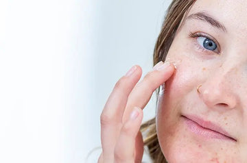 A photo of Emma, a Simple Body customer, applying Wrinkle Defense Serum with all-natural, plant-based ingredients.