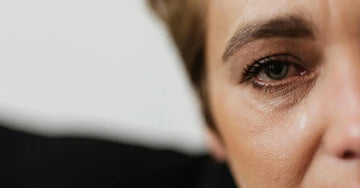 A close up photo of a woman looking concerned about her skin