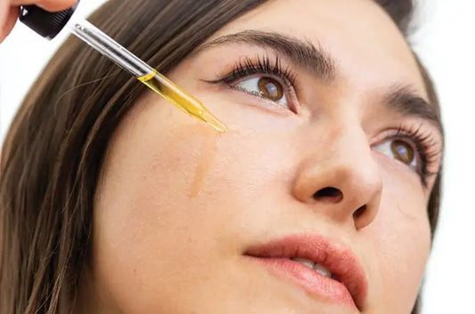 A photo of Sara, a Simple Body Customer, applying Simple Body Nightly Face Serum to her cheek.