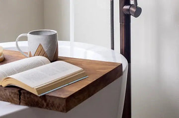 A photo of Jewels Burdick, Founder of Simple Body's bath time routine which includes a cup of tea, a book, a natural bath bomb and bath salts.