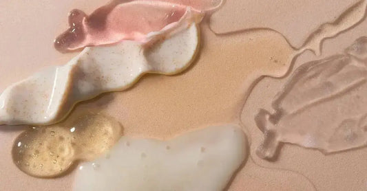 A photo of various skincare textures including serums, gels, creams on a beige background