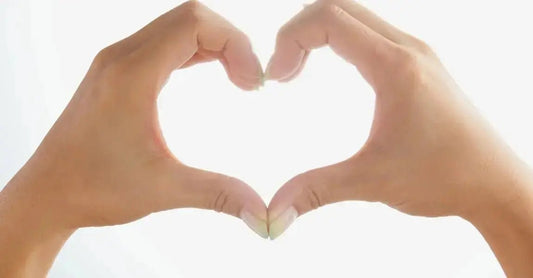 A pair of women's hands forming the shape of a heart