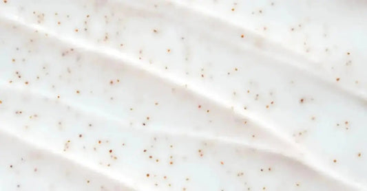 A very close up image of Simple Body Bamboo Face Polish with the texture very visible, but in a creamy white lotion.