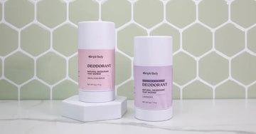 A photo of The Best Natural Deodorant Simple Body All-Natural Deodorant including Himalayan Magic and Baking Soda Free Lavender sitting in front of a mint green tile wall.