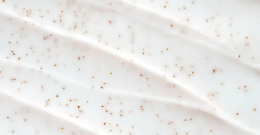 A very close up image of Simple Body Bamboo Face Polish with the texture very visible, but in a creamy white lotion.