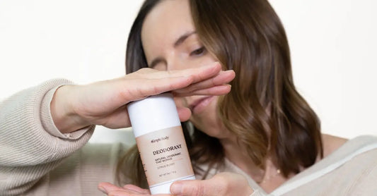 A photo of Ashley, a Simple Body customer holding up a Simple Body All-Natural Deodorant in Citrus Burst.