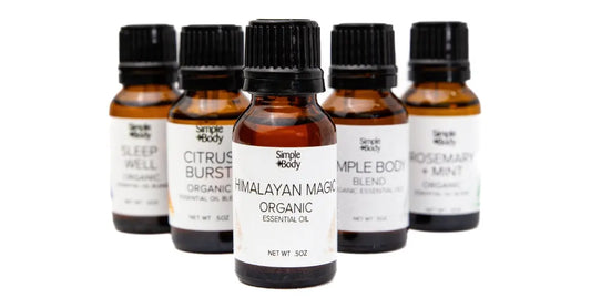 A photo of Simple Body Essential Oils including Himalayan Magic, Simple Body, Citrus Burst, Sleep Well, and Rosemary Mint blends.