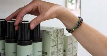 A photo of Jewels Burdick, our founder with her hand reaching for a Clean Sweep Toner.