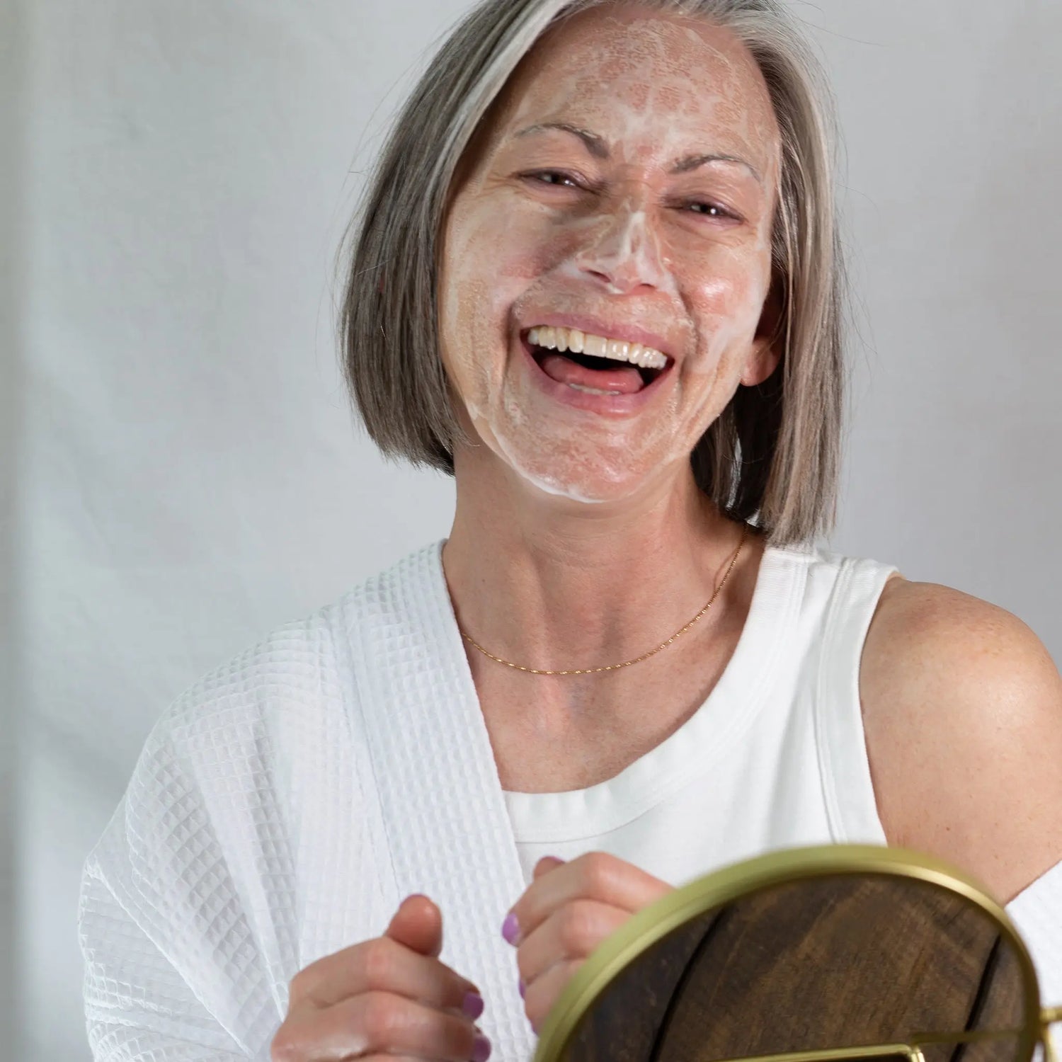 Michelle laughs as she's cleansing her face with Simple Body Foaming Face Wash from our Cleansers Collection.