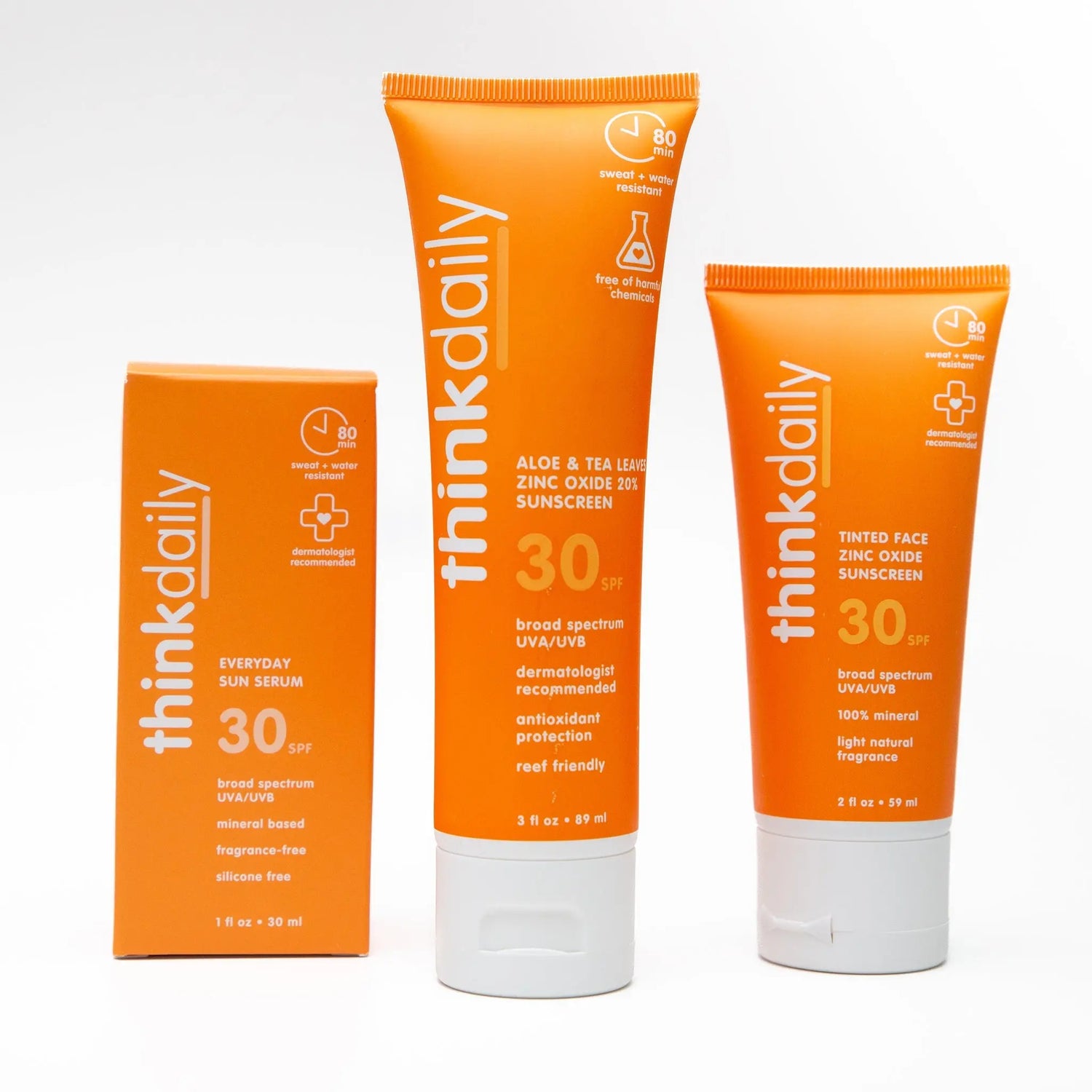 A photo of three natural, mineral daily facial sunscreens by Think with bright orange packaging.