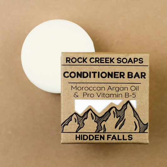 Rock Creek Soaps conditioner bar with packaging on a brown background