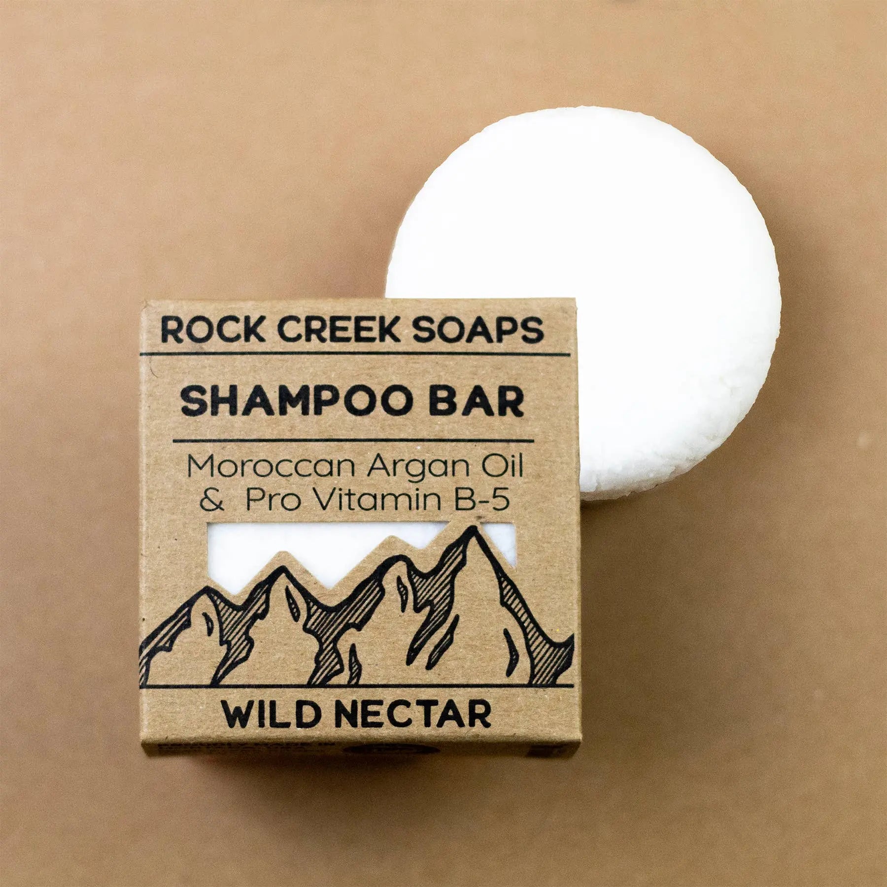Shampoo bar with packaging labeled 'Rock Creek Soaps' on a brown background