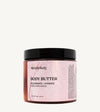 Jar of Simple Body Himalayan Magic body butter with pink label on tan background