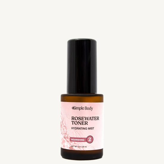 A bottle of Rosewater Face Toner by Simple Body. The bottle is amber transparent with a black cap.