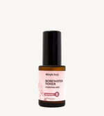 A bottle of Rosewater Face Toner by Simple Body. The bottle is amber transparent with a black cap.