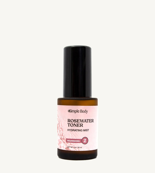 A bottle of Rosewater Face Toner by Simple Body. The bottle is amber transparent with a black cap.