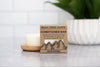 Rock Creek Soaps conditioner bar on a countertop with a blurred background