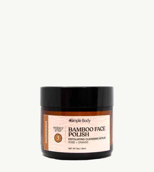 A jar of Simple Body Bamboo Face Polish with the label showing the product name and the scents, rose and orange.