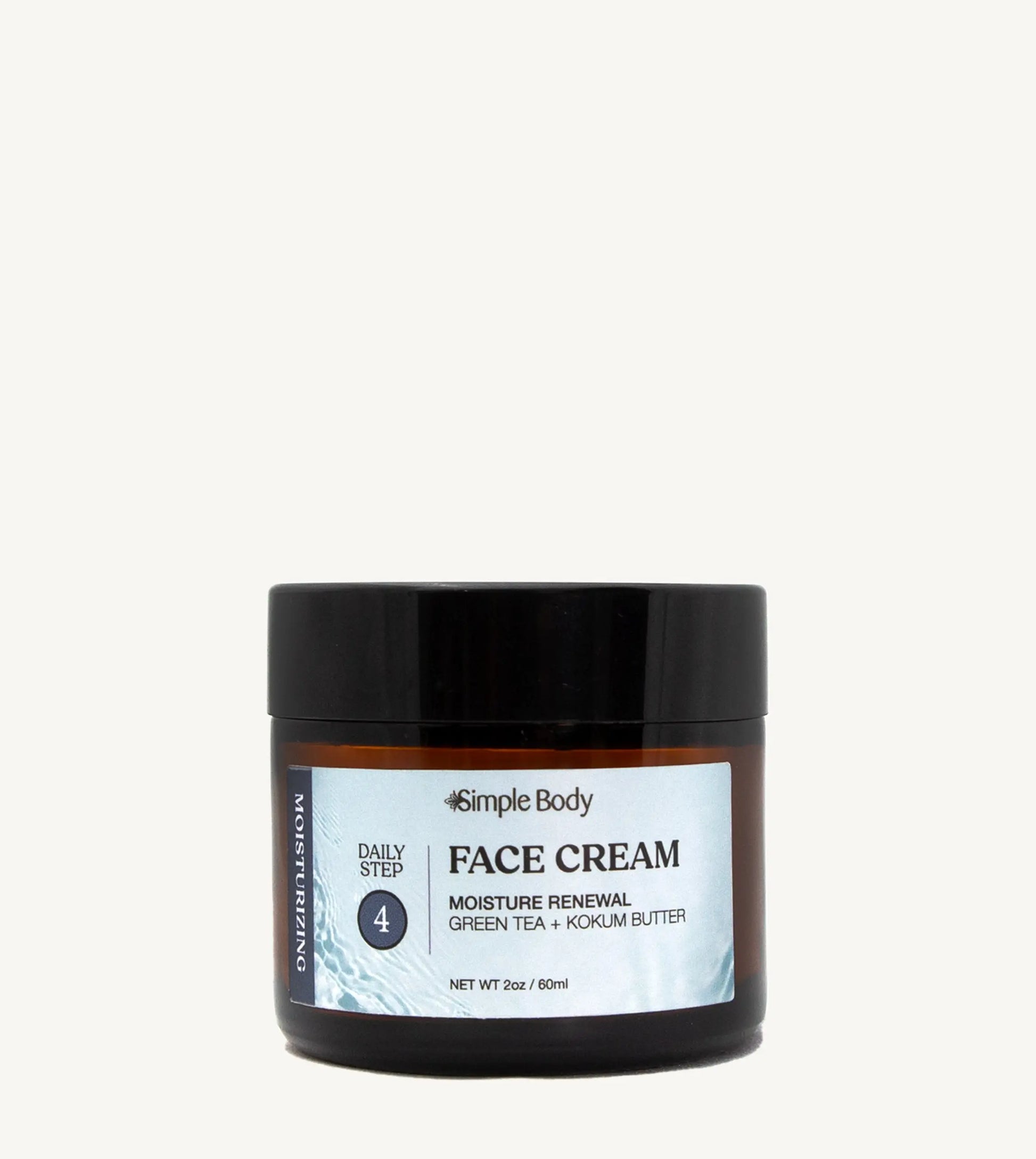 A recyclable glass jar of Simple Body Face Cream with a black lid and a label that includes the product name and a brief description.