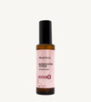 A bottle of Rosewater Face Toner by Simple Body. The bottle is amber transparent with a black cap.
