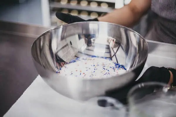 Metal bowl with colorful sprinkles on a kitchen counter
