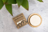 Shampoo bar from Rock Creek Soaps with packaging on a concrete surface