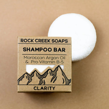 Rock Creek Soaps shampoo bar with packaging on a beige background