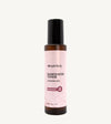 A bottle of Rosewater Face Toner by Simple Body. The bottle is amber transparent with a black cap.
