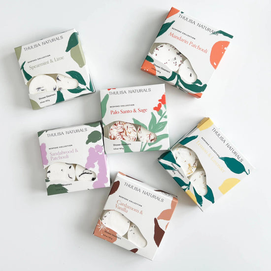 Collection of Thulisa Naturals Shower Steamer Gift boxes on a white background