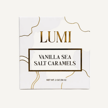 LUMI Vanilla Sea Salt Caramels packaging box, featuring a white background with elegant gold wavy lines and gold lettering.
