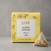 Lumi Lemon Ginger herbal tea package with a pyramid tea bag on a gray background