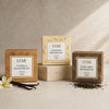 Three LUMI tea packages on a neutral background with vanilla beans and a flower.