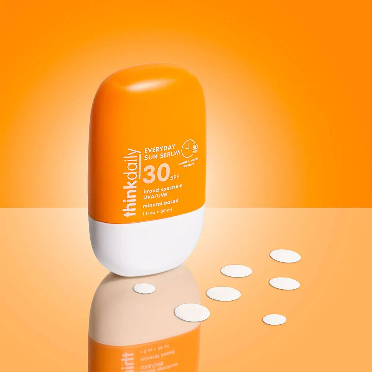 Orange and white bottle of think daily Everyday Sun Serum SPF 30 on an orange background