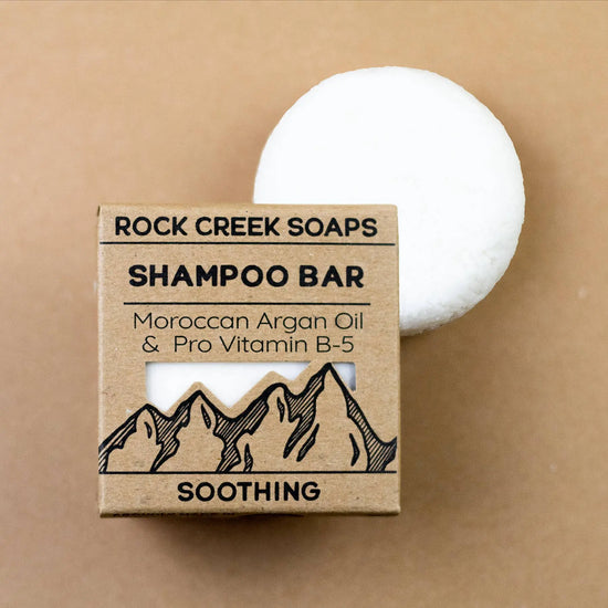Rock Creek Soaps shampoo bar with packaging on a beige background