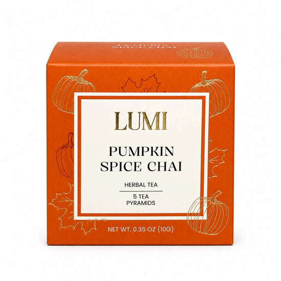 LUMI Pumpkin Spice Chai herbal tea box, featuring an orange packaging design with gold pumpkin illustrations and a central white label with gold and black text.