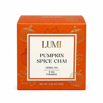 LUMI Pumpkin Spice Chai herbal tea box, featuring an orange packaging design with gold pumpkin illustrations and a central white label with gold and black text.