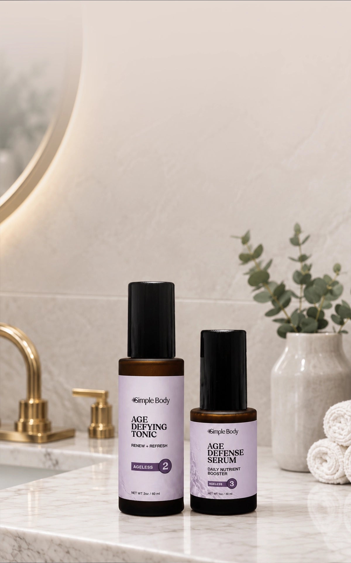 Simple Body Ageless Duo with Age Defying Tonic and Age Defense Serum on a marble bathroom counter.