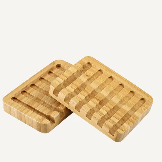 Two wooden blond colored bamboo soap trays on a white background
