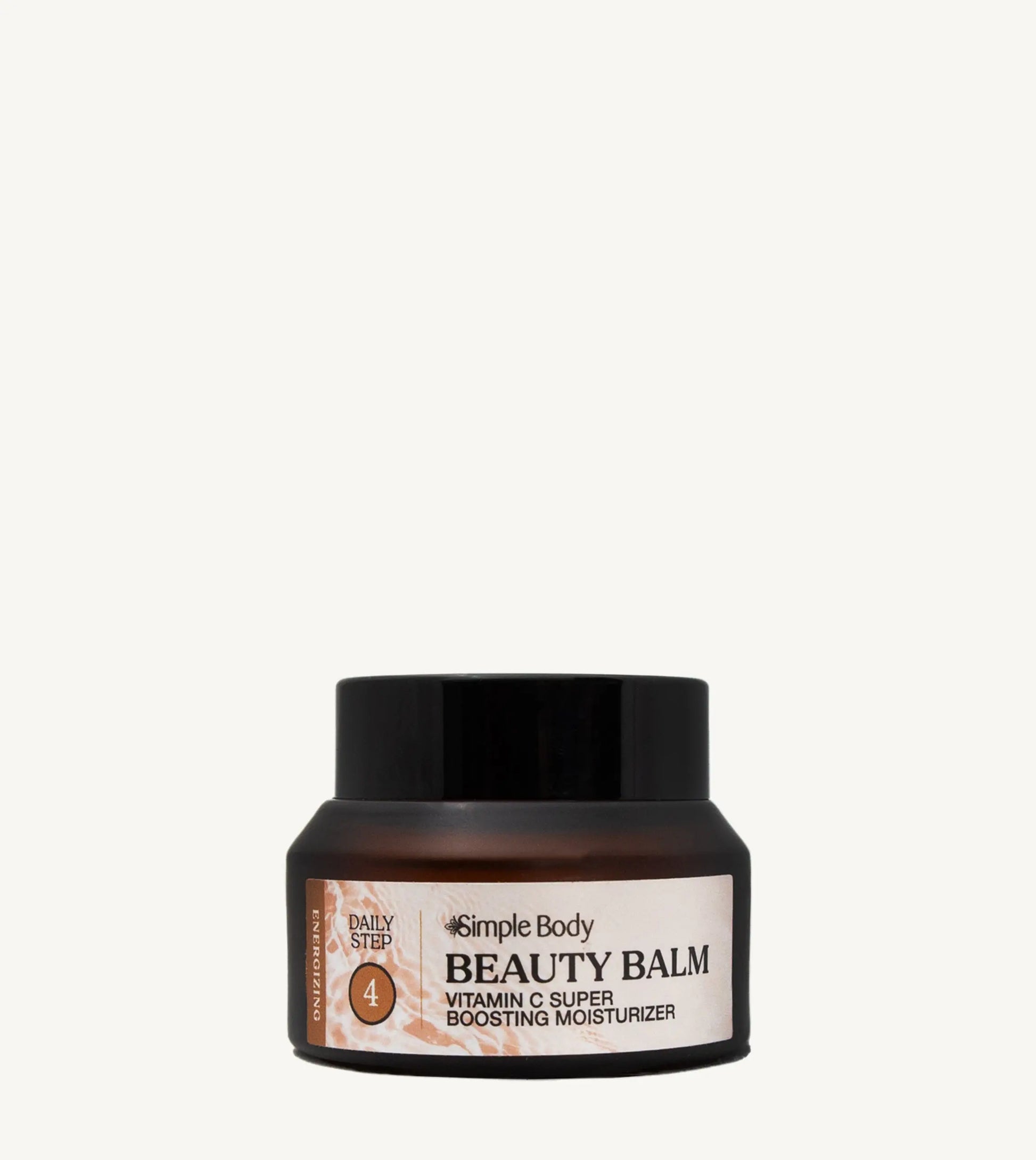 Beauty balm jar with black lid and peach colored label on a light tan background