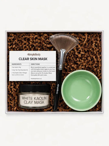 A Simple Body Clay Mask Kit with a White Kaolin Clay Mask, Green Bowl, Fan Brush and recipe card with kraft crinkle paper in a gift box.