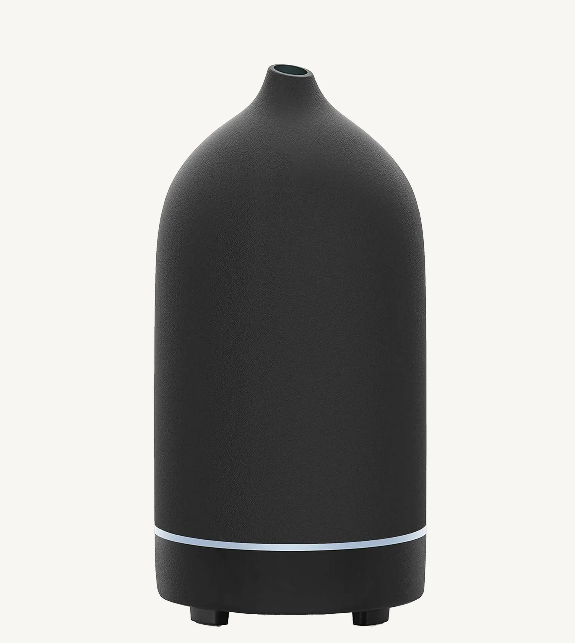 A modern ceramic essential oil diffuser in black against a white background.