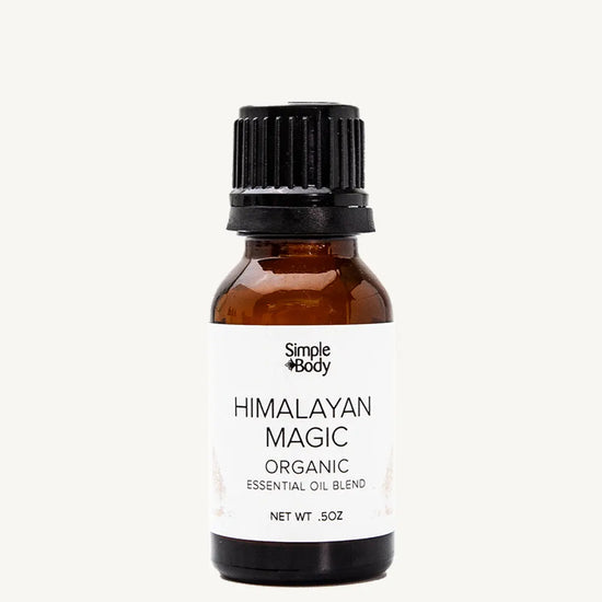Brown glass bottle of Simple Body Himalayan Magic Organic Essential Oil Blend on a white background