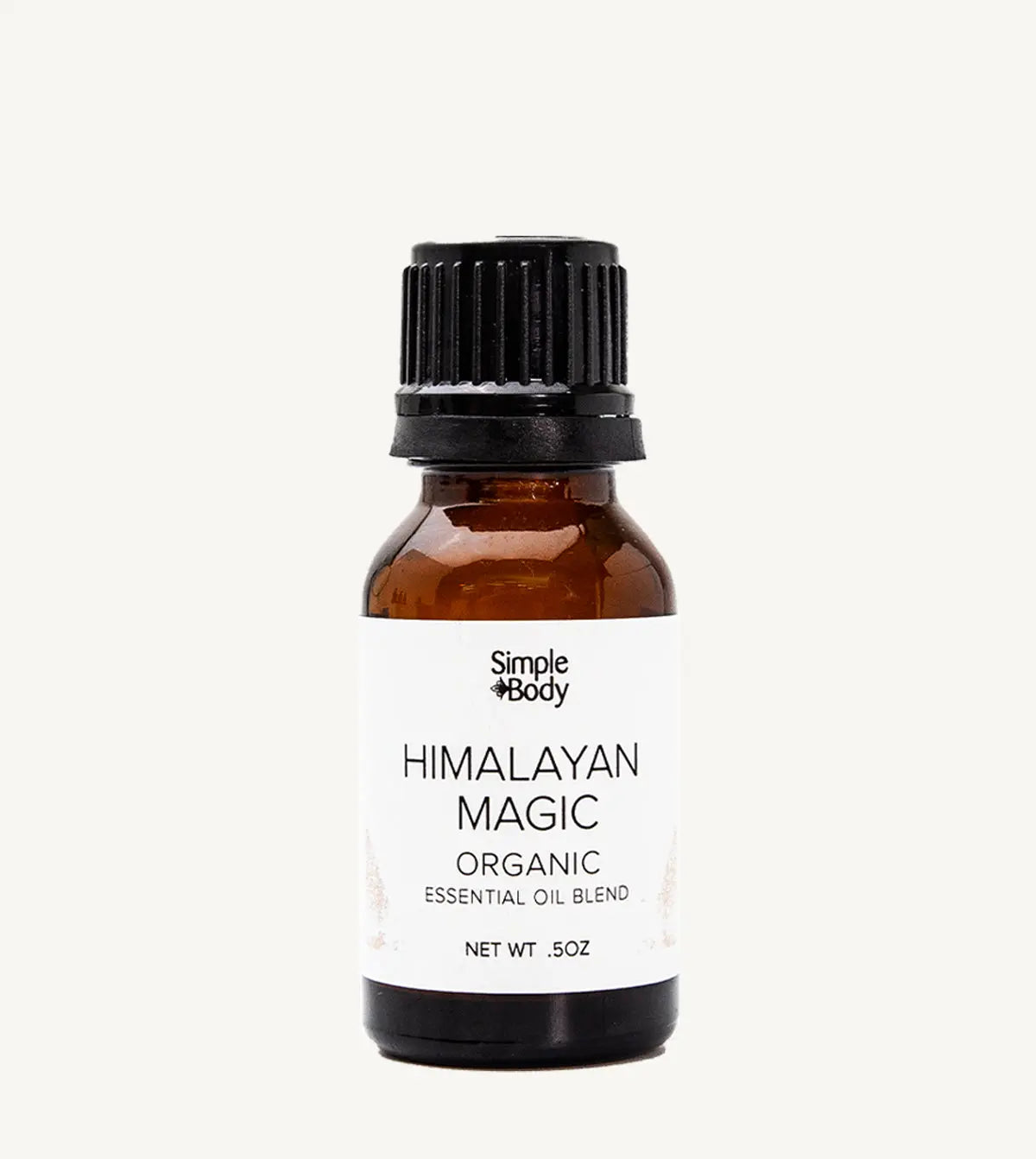 Brown glass bottle of Simple Body Himalayan Magic Organic Essential Oil Blend on a white background
