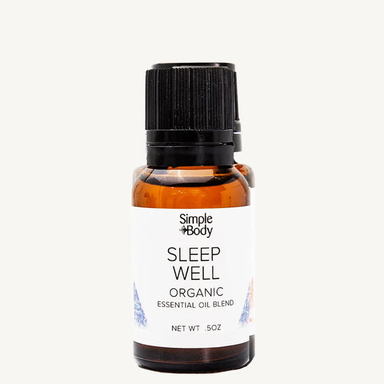 Bottle of Simple Body Sleep Well organic essential oil blend on a white background