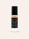 A small cylindrical bottle of Geranium Rose Perfume Oil by Benjamin Soap Co, featuring a black cap and a black label with white text, set against a solid off-white background.