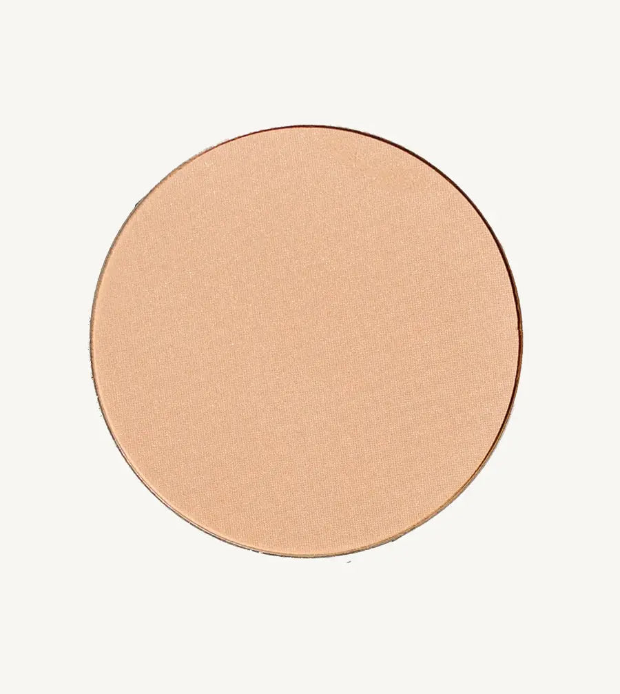 A photo of Pure Anada's Pressed Translucent Finishing Powder in Glow which is a warm peach with a slight shimmer on a tan background.