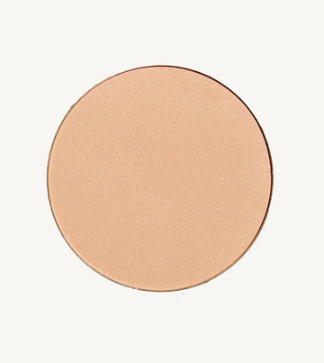A photo of Pure Anada's Pressed Translucent Finishing Powder in Glow which is a warm peach with a slight shimmer on a tan background.