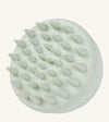 A photo of a mint green hair and scalp brush by Simple Body