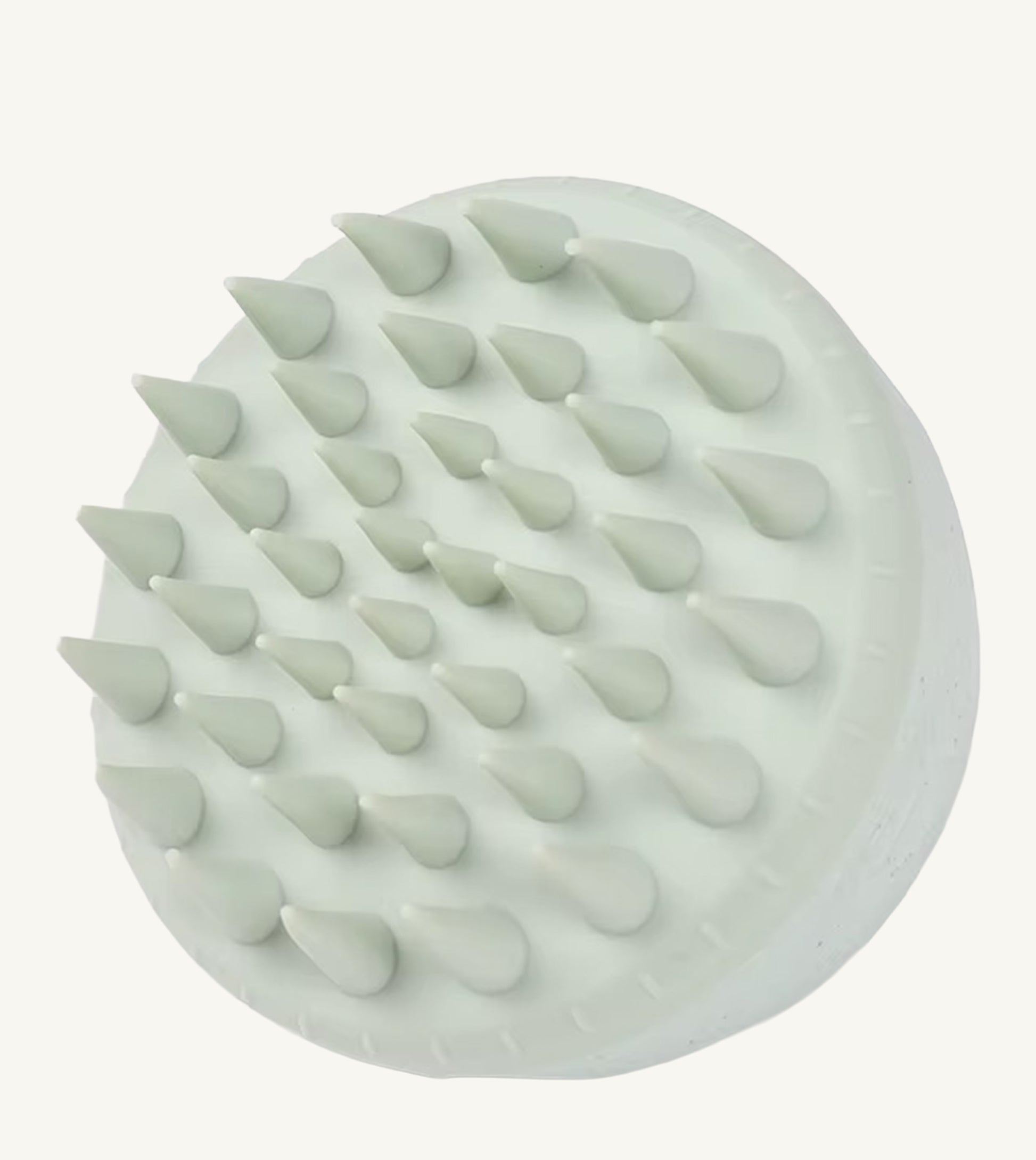 A photo of a mint green hair and scalp brush by Simple Body
