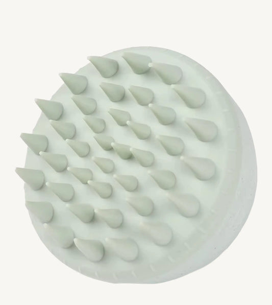 A photo of a mint green hair and scalp brush by Simple Body